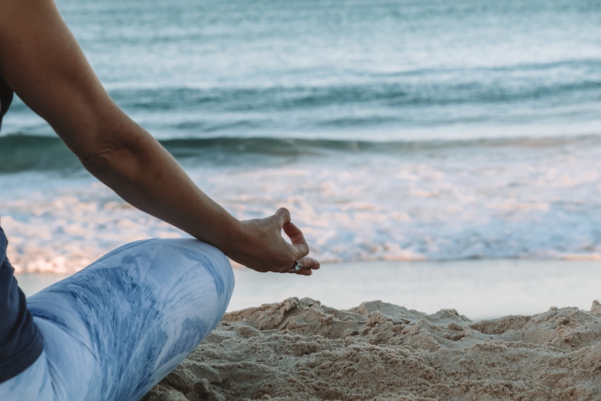 Femme pratiquant la méditation de pleine conscience au bord de la mer